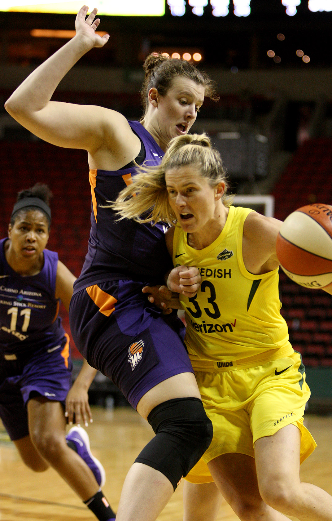 Sami Whitcomb of the Storm dribbles into the defensive pressure of the Mercury's Chatrice White.