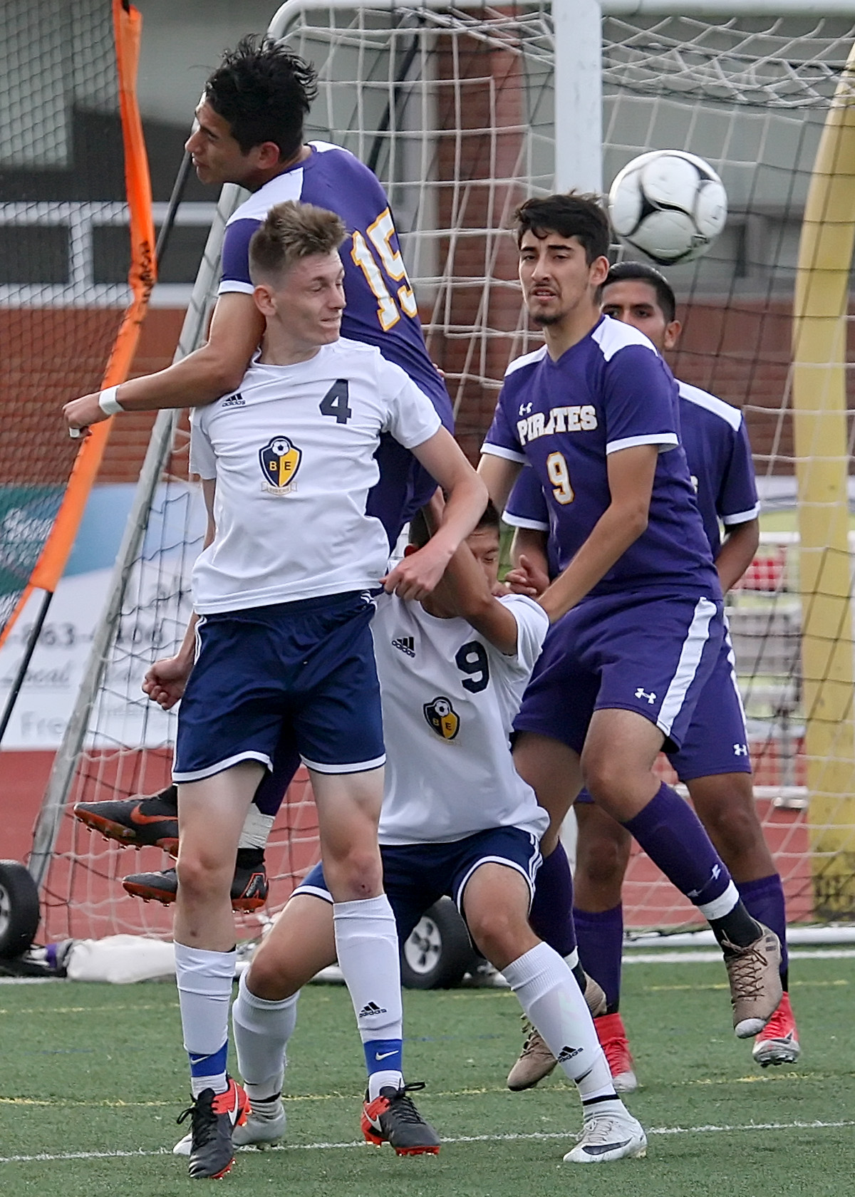  Highline and Burlington Edison players jump for the ball near Highline's goal.