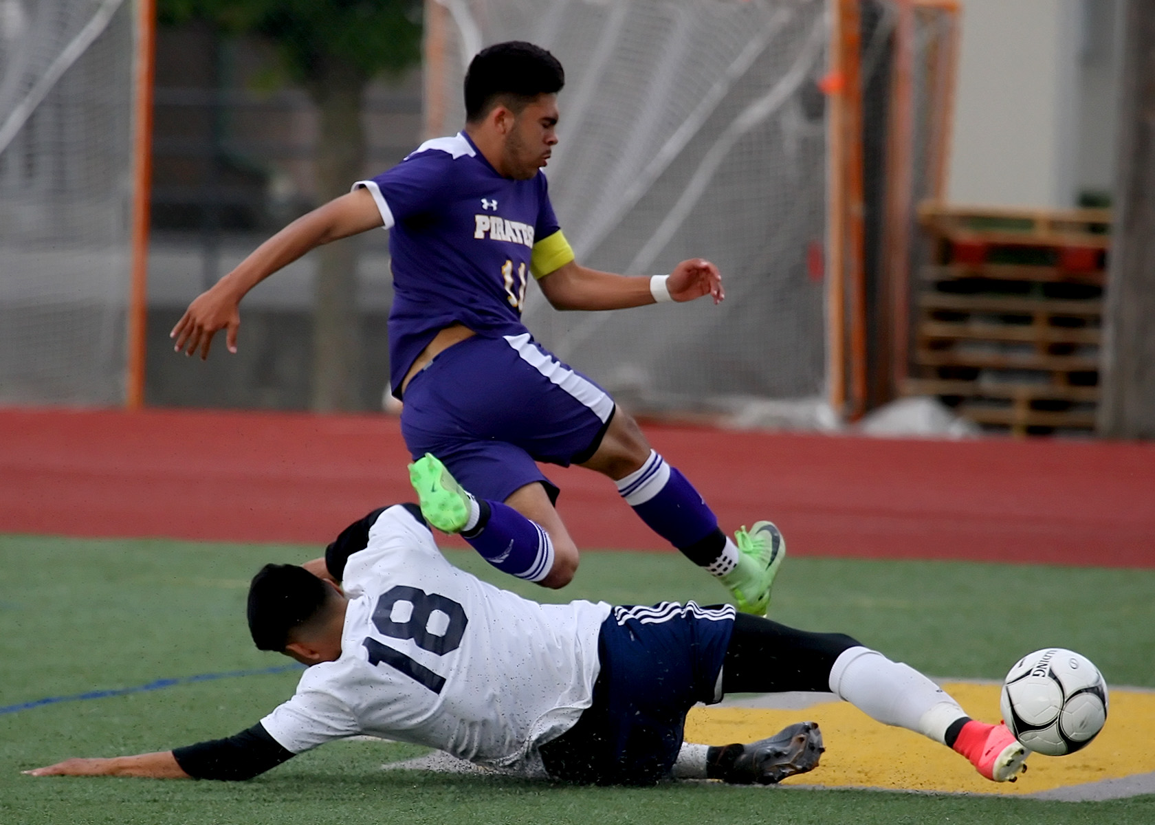 Leandro Anaya of Highline hurdles over Kevin Tinoco of Burlington Edison.