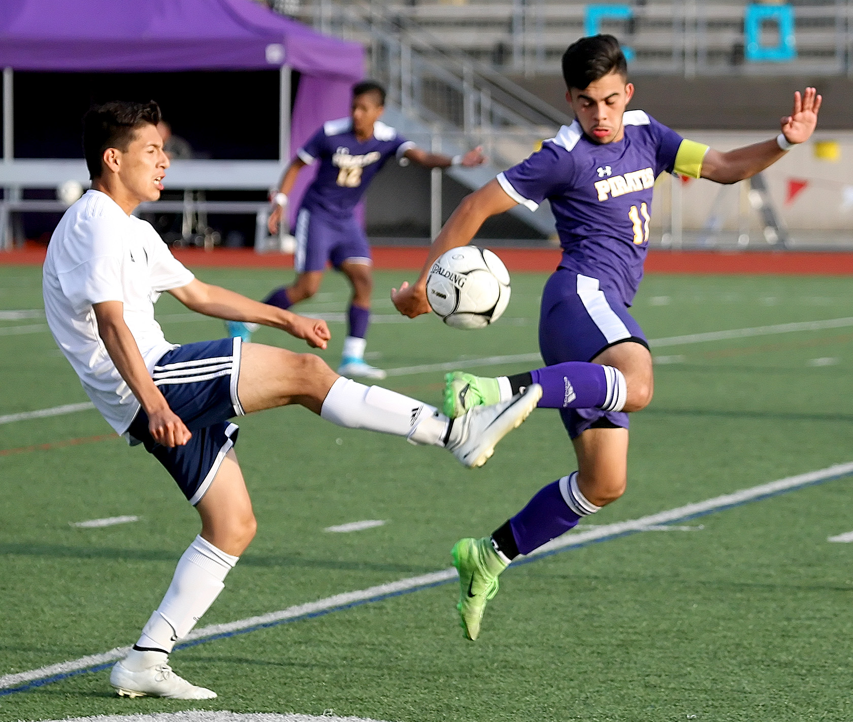 Hernan Moreno of Burlington Edison and Highline's Leandro Anaya kick each others foot going for the ball.