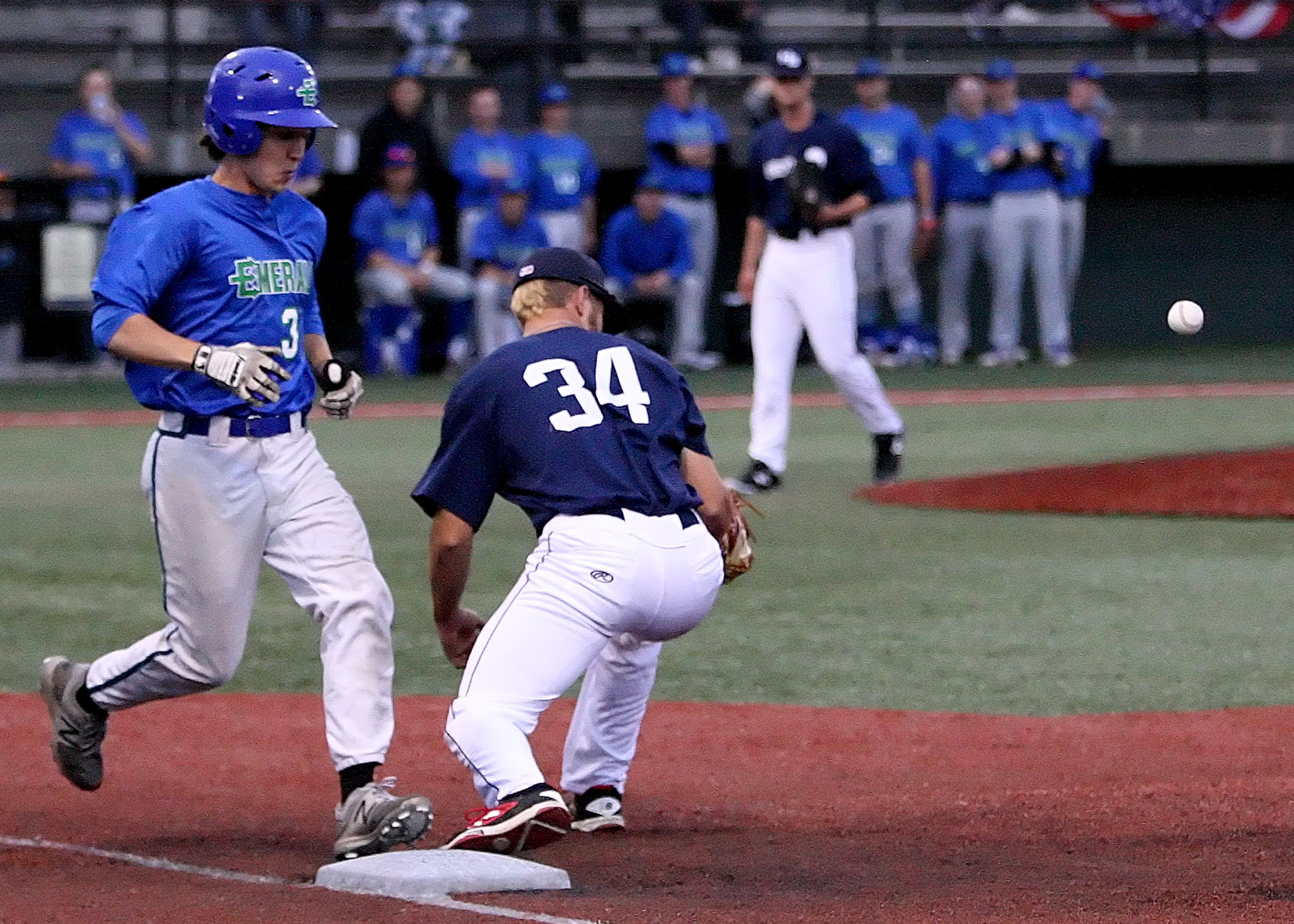 Carson Lindell of the Emeralds is safe at first as the ball gets away from the Bears Bryce Beck. 