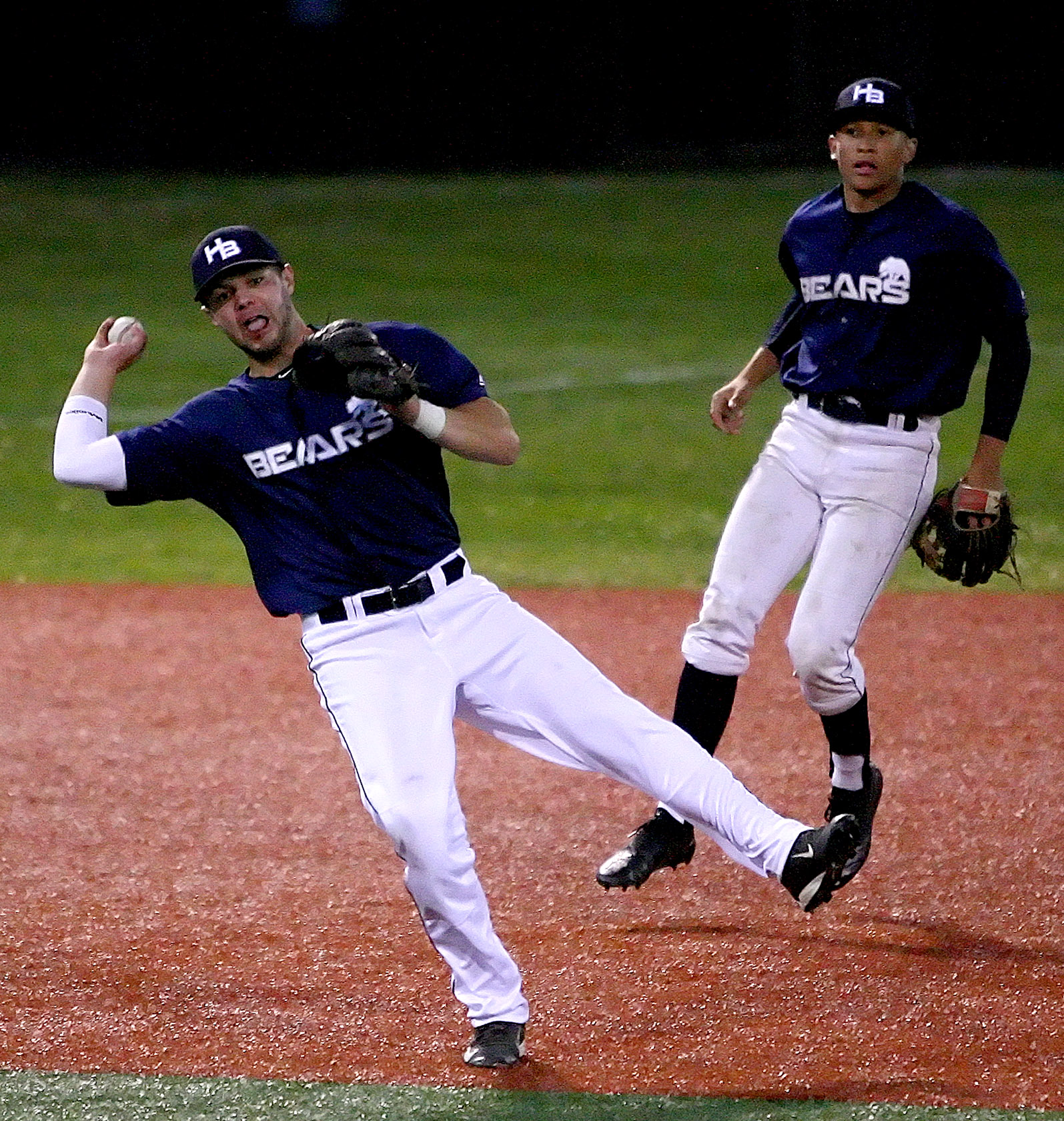 Carter Wallace of the Bears makes an off balance throw to first base for an out.