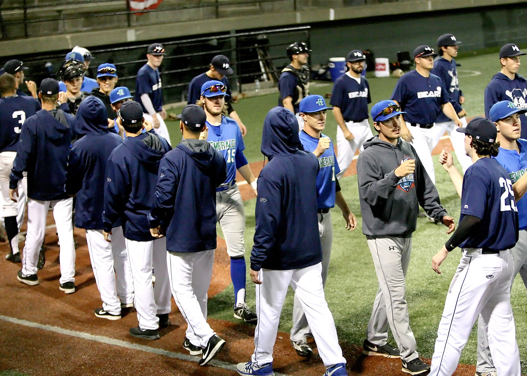 he Bears and the the Emeralds give each other fist bumps after the game.