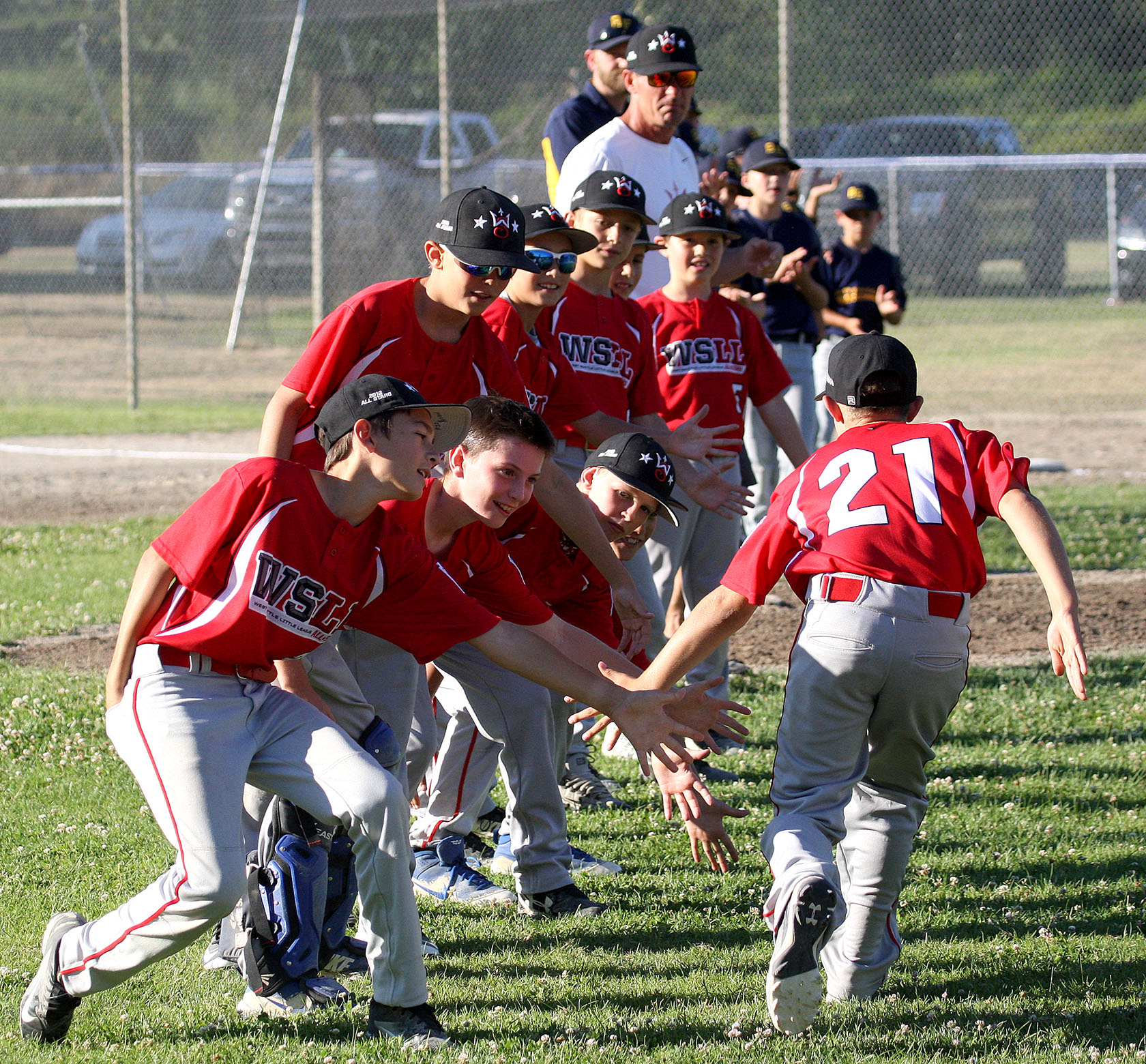 During team introductions Jones Kasperson of West Seattle gets low fives from his teammates.