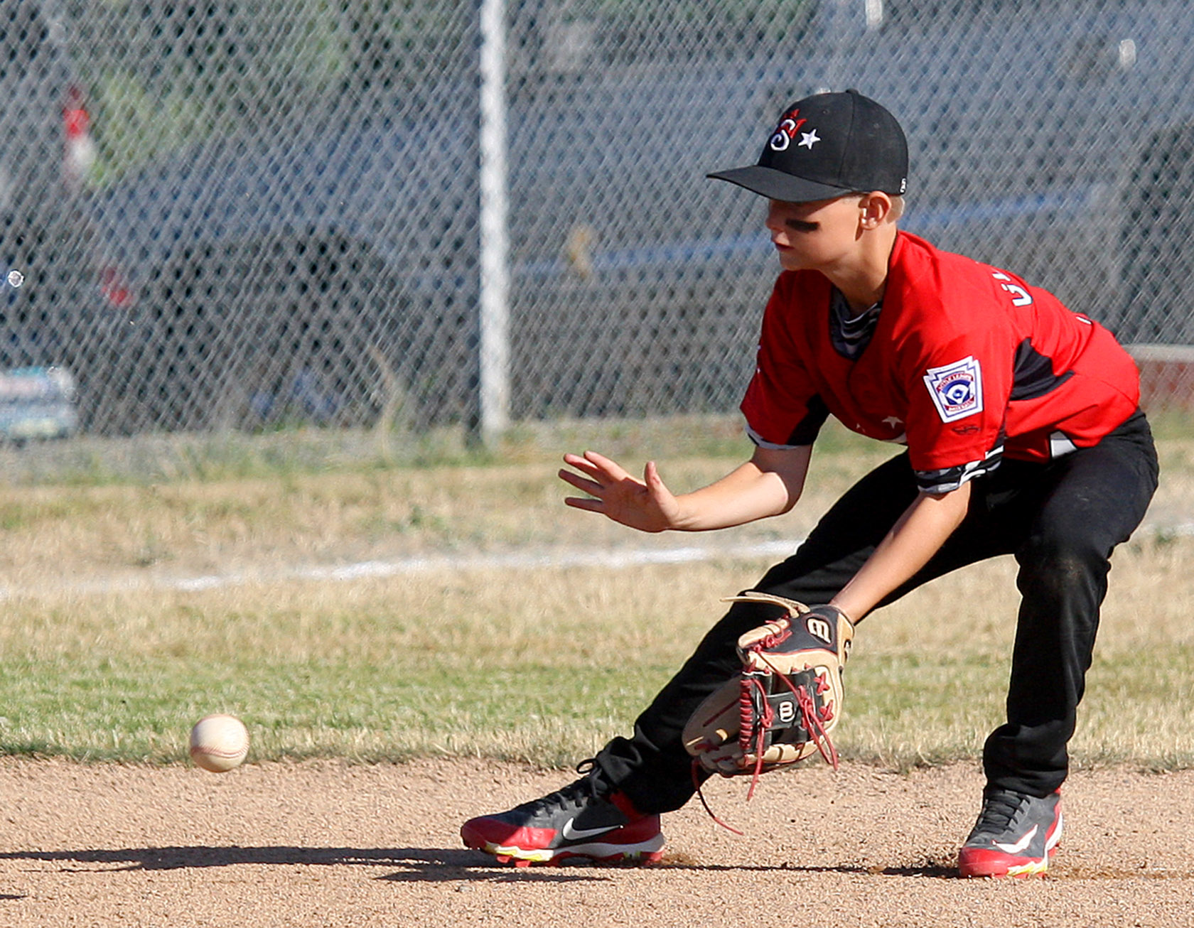 Short stop Wyatt Glover of West Seattle fields a ground ball.