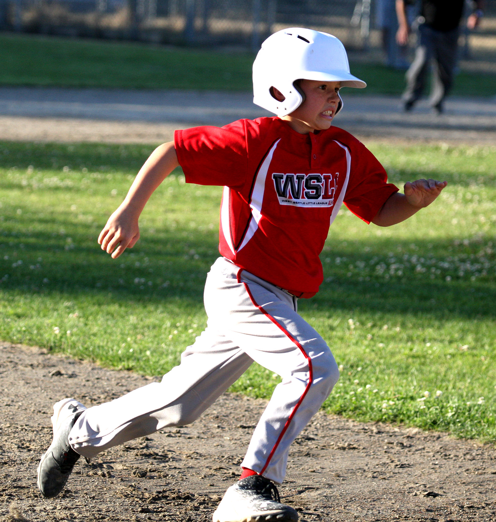 Jesse LaBella of West Seattle puts it into high gear as he heads to third.