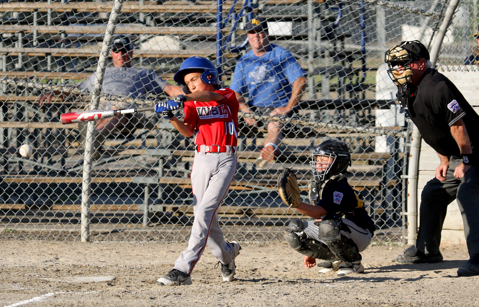 Cameron Fitterer of West Seattle gets a base hit down the third base line.