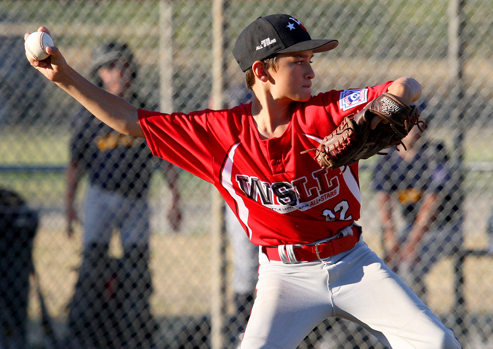 Starting pitcher Hudson Harding of West Seattle delivers his pitch to home plate.