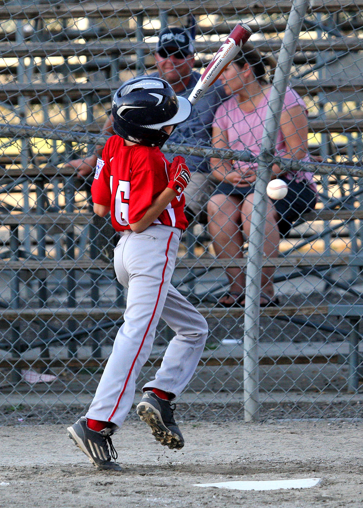 Andrew Rhinehart of West Seattle is hit by a pitch.