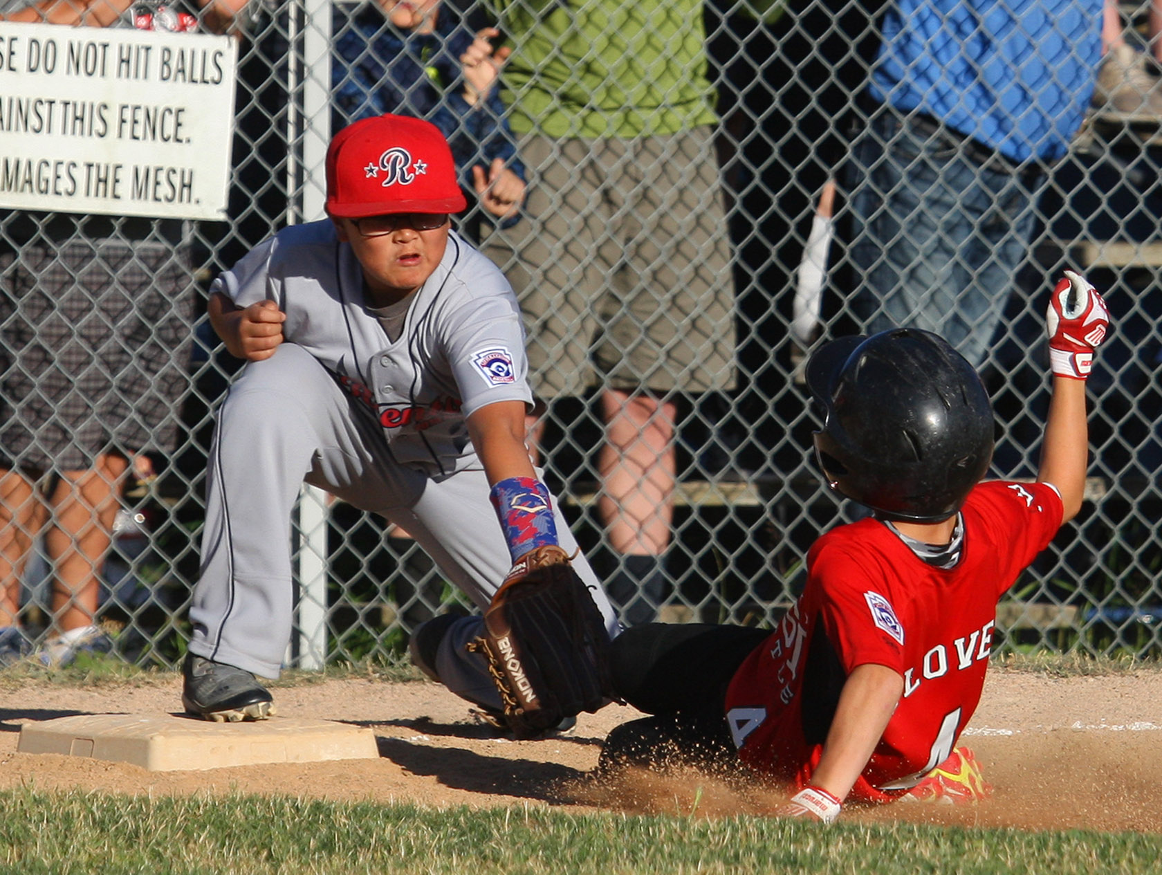 Wyatt Glover of West Seattle is tagged out by Renton's 3rd baseman Ethan Sugimoto attempting a triple. 