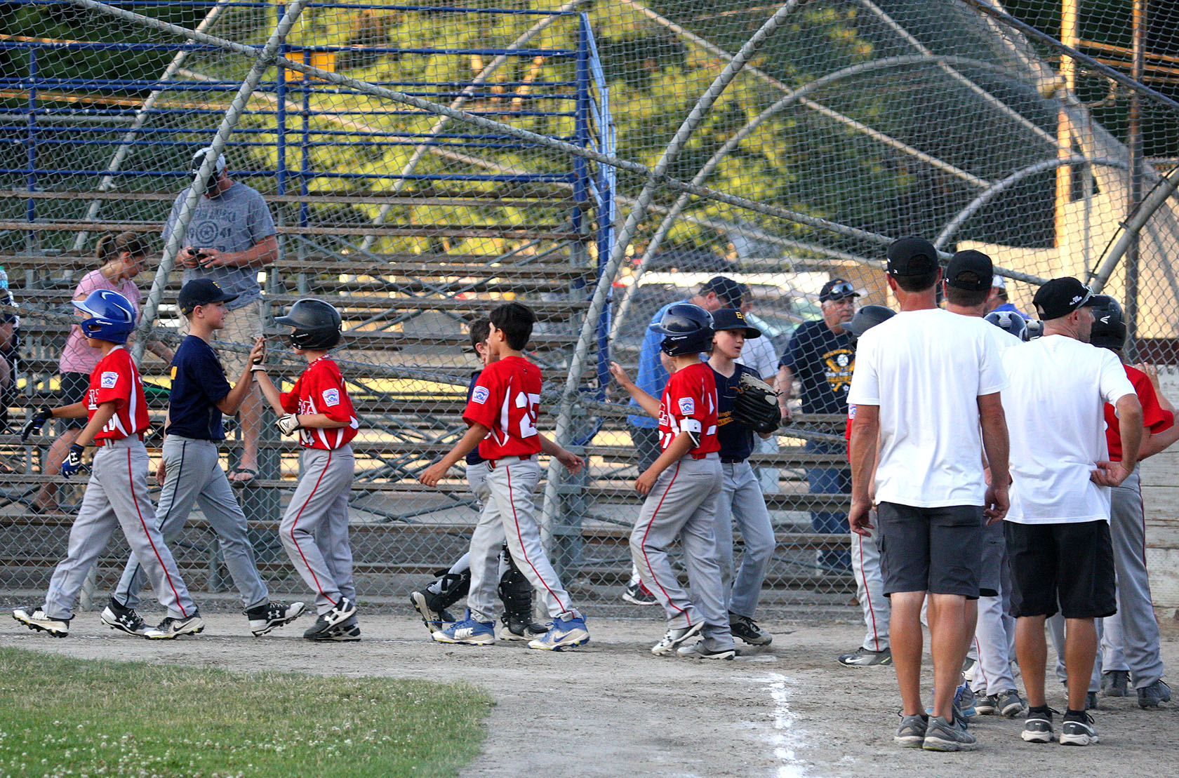 West Seattle and Burlington Edison players give each other the traditional high five after the game.