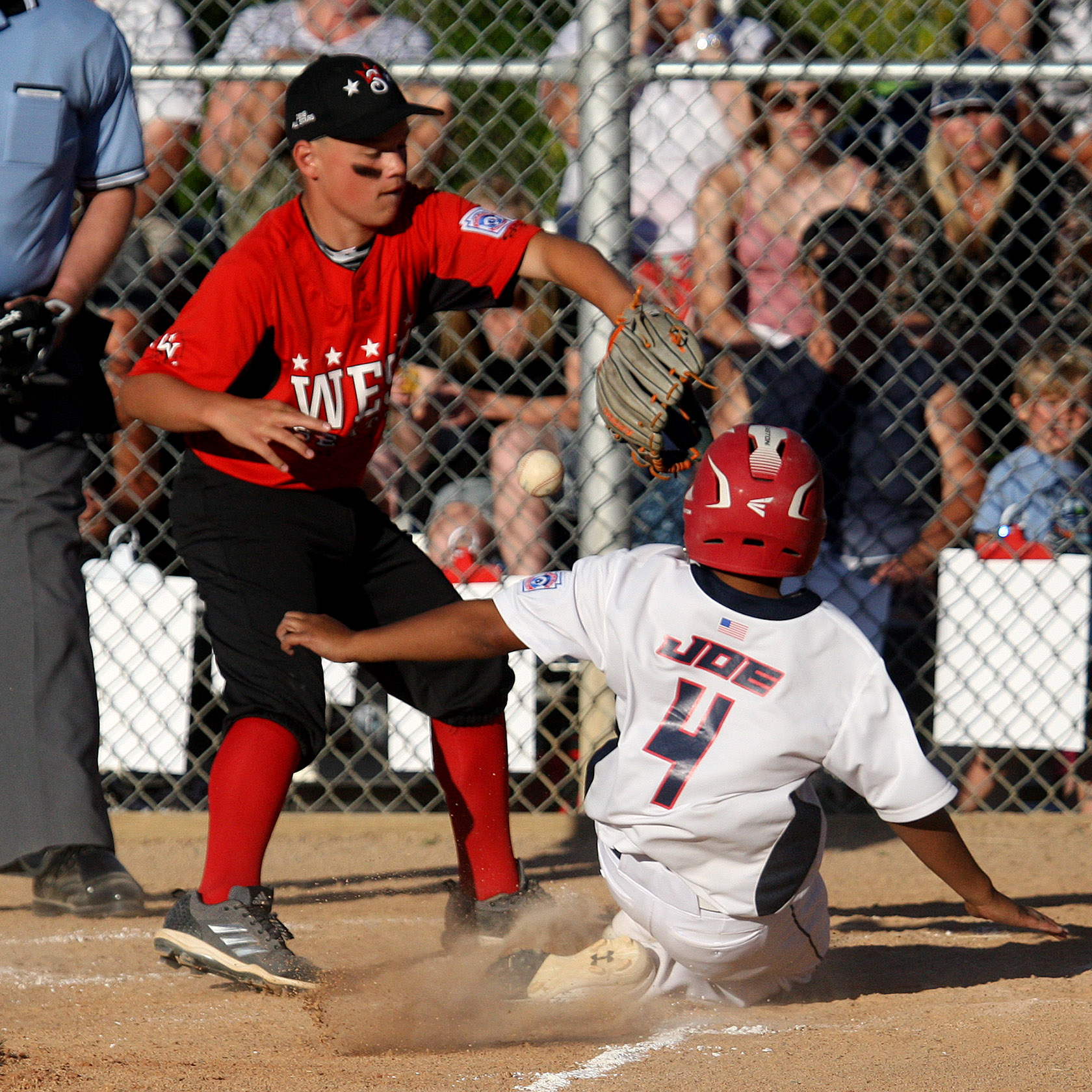 Jeffery Joe of South Highline Nationals scores as West Seattle's Laden Fahy can't control the ball.