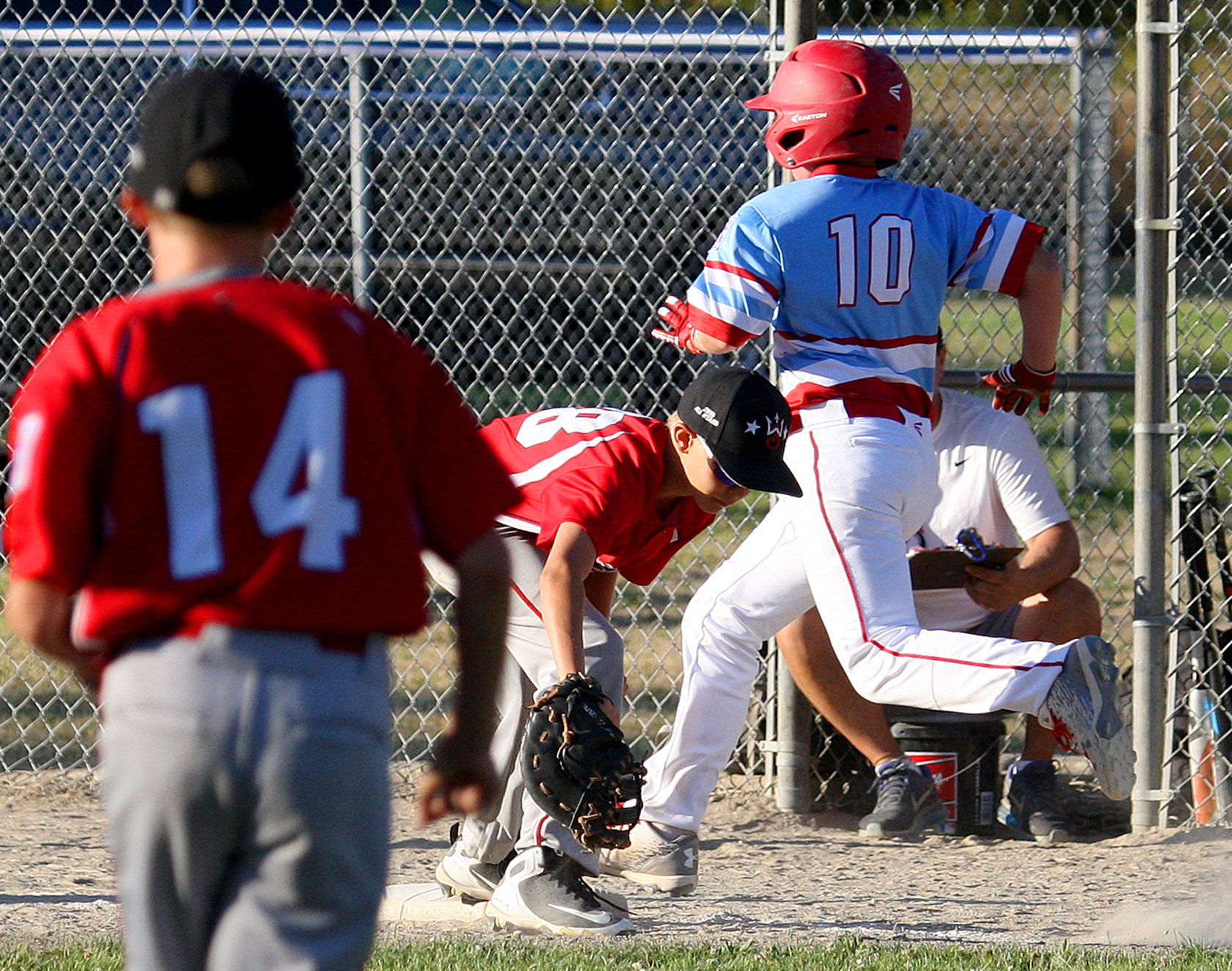 Duncan Monnin of West Seattle gets West Valley's Jayden Ritch out at first.