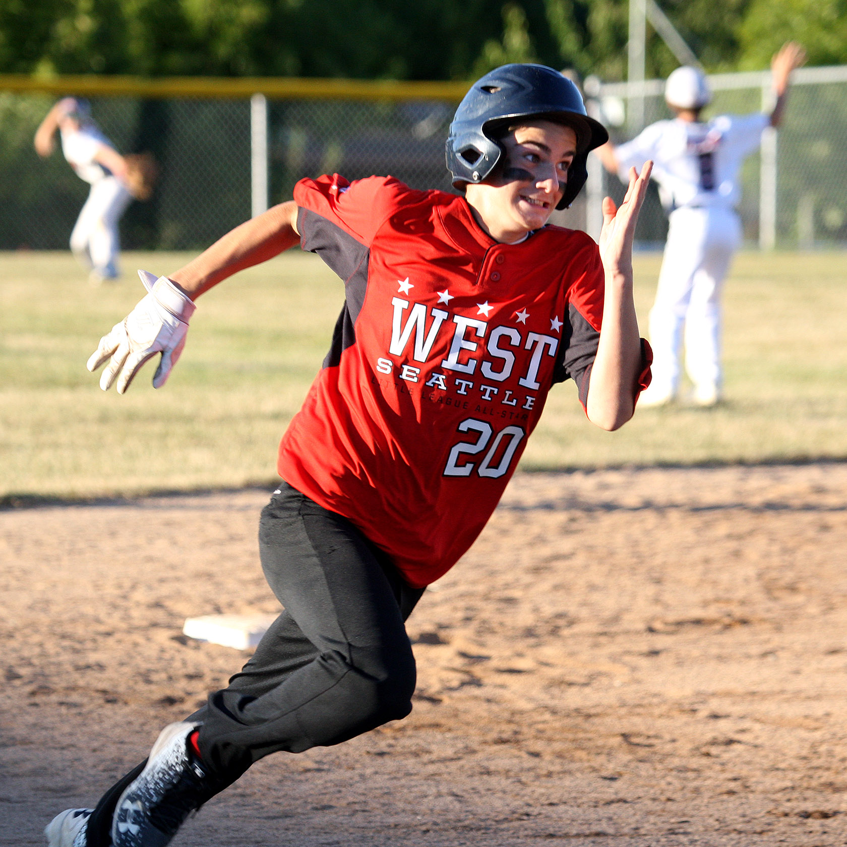 Base runner Eli Palmer of West Seattle heads for third.