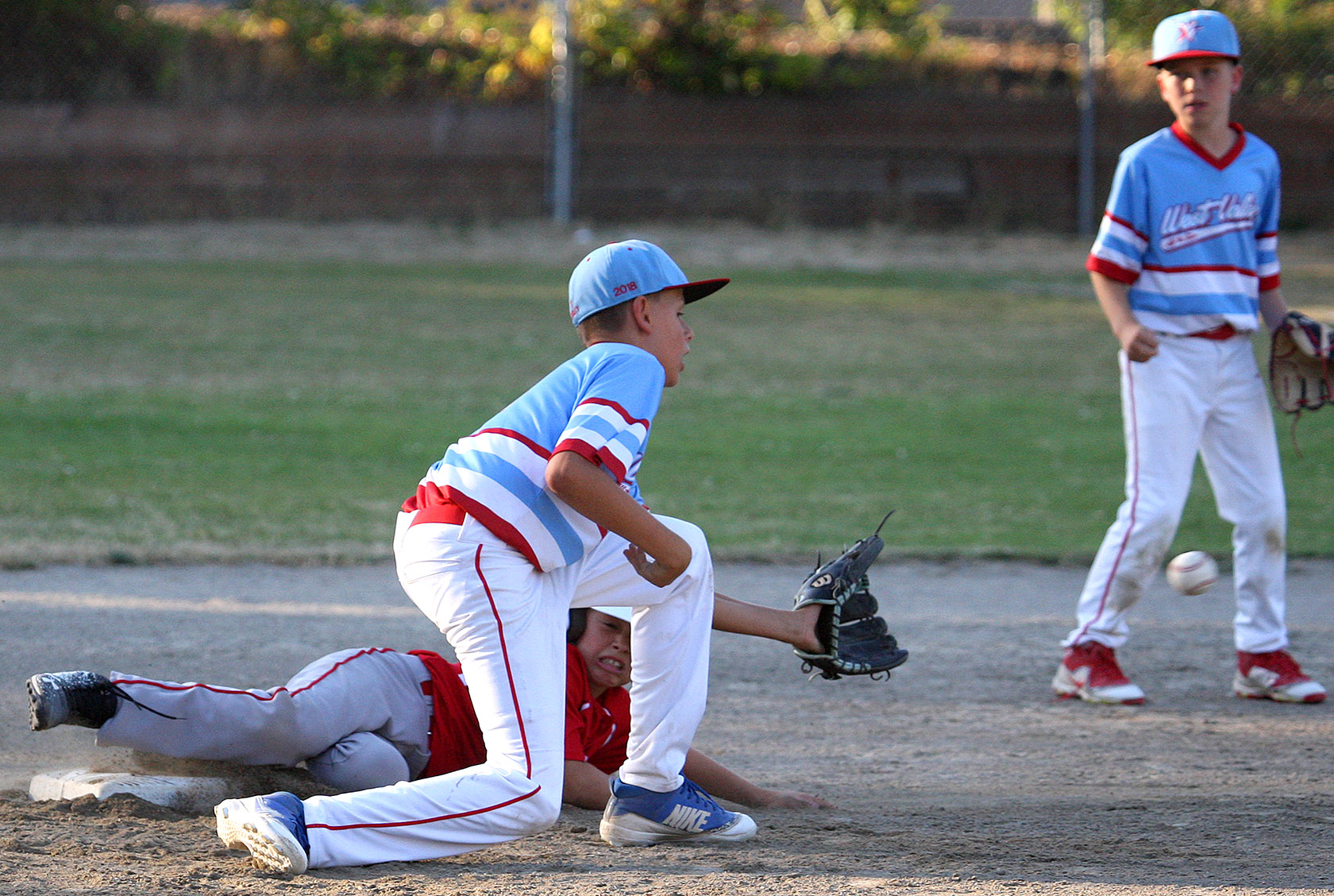  Jesse LaBella of West Seattle slides safely into second base against West Valley's Branden Birley.