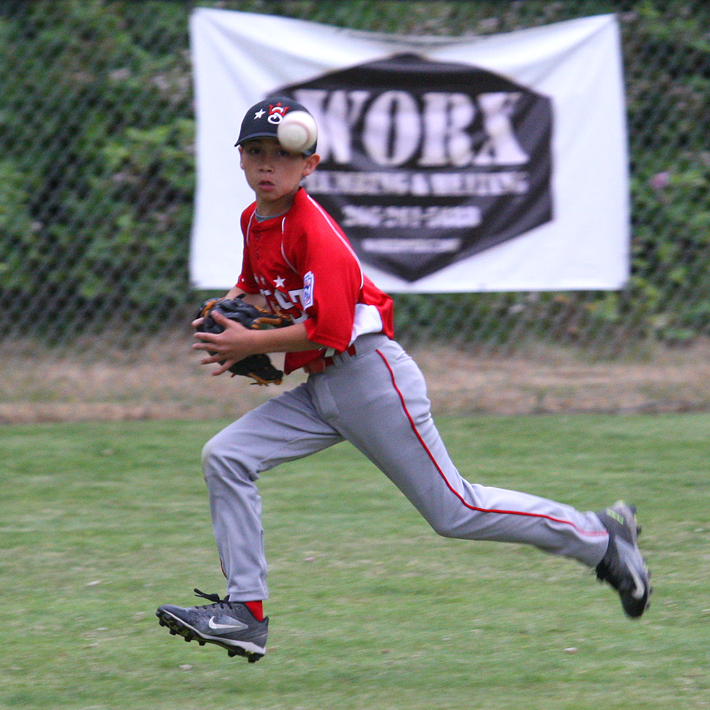 Center fielder Bryce Alonzo of West Seattle keeps his eyes on the ball.