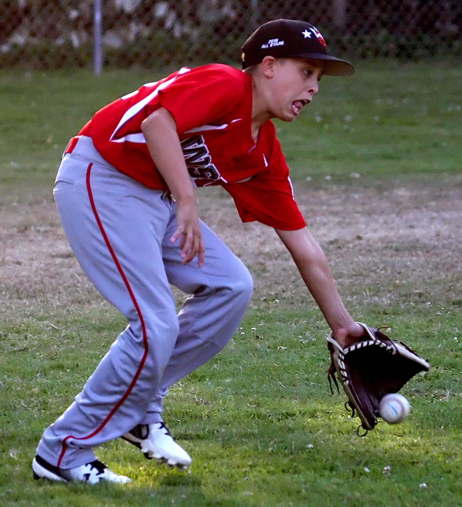 Left fielder Jones Kasperson of West Seattle snags the ball.