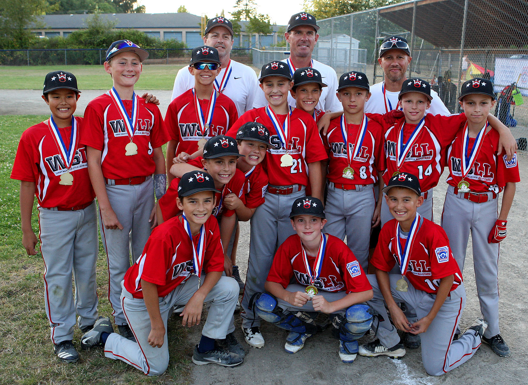 West Seattle players and their coaches pose for a team photo after the game.