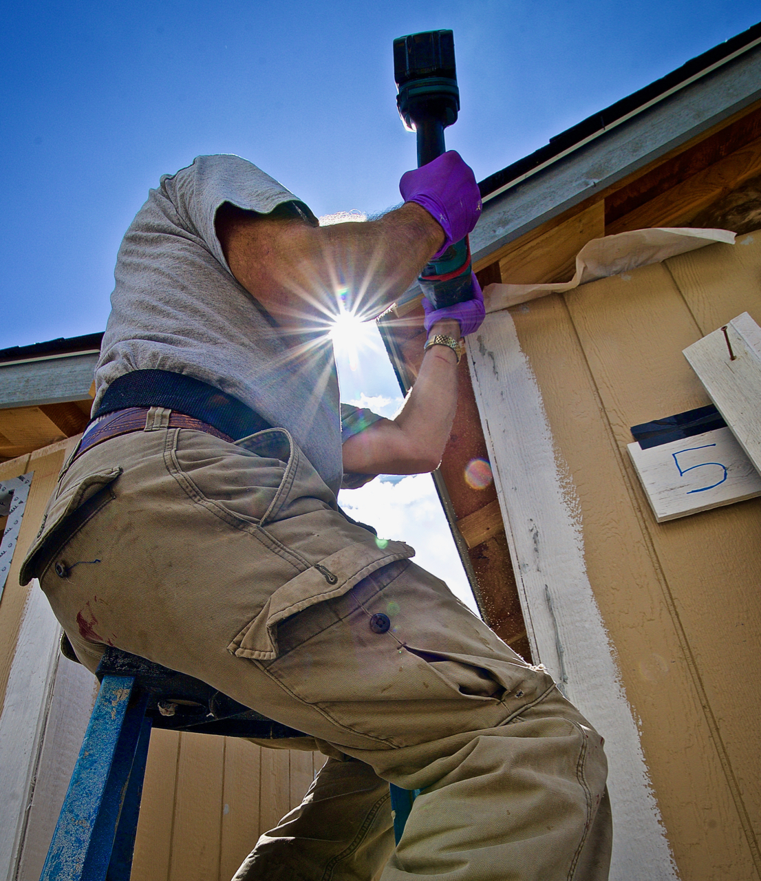 workman on tiny house