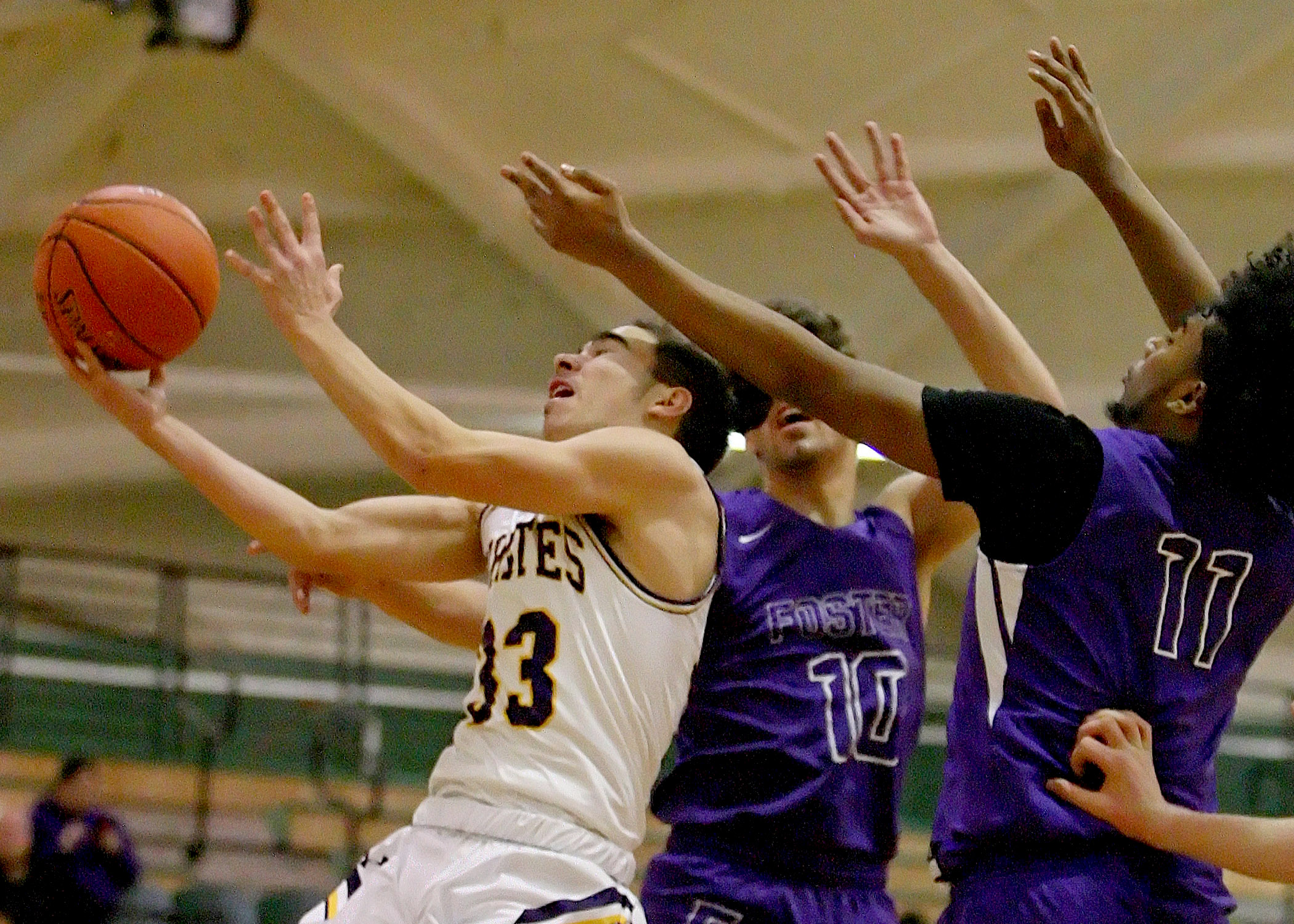 Malakai Carter of Highline is fouled driving to the basket.