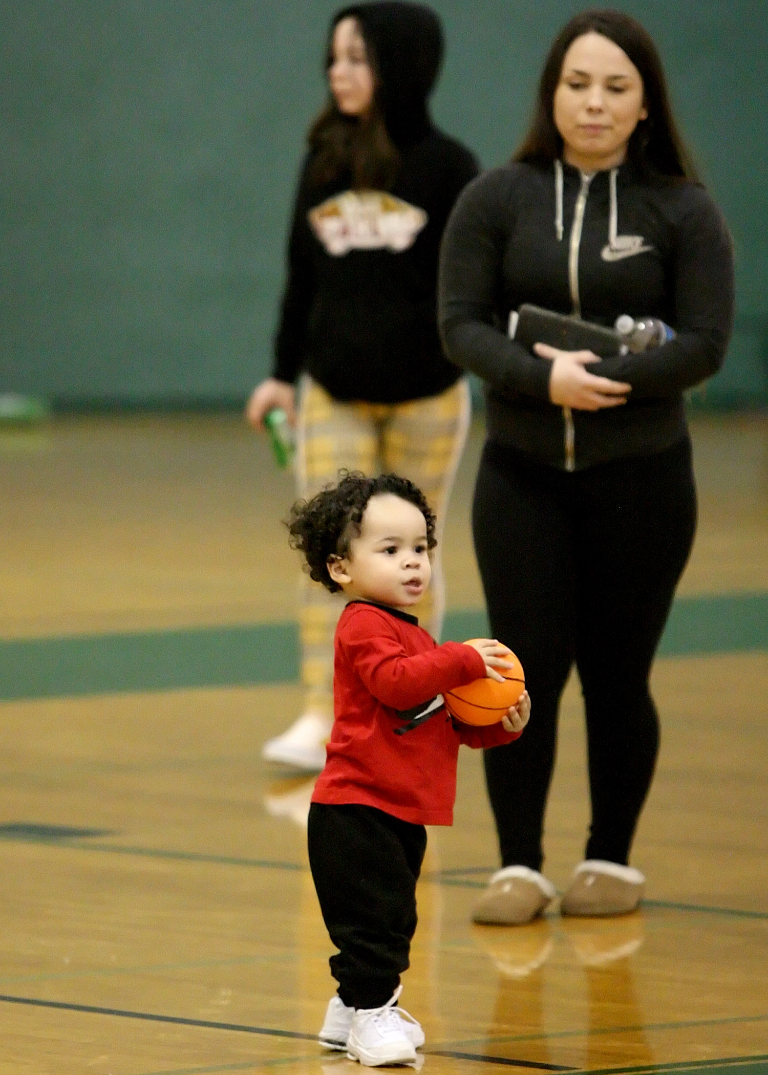 At half time young Maurice enjoyed his time on the court with his basketball.