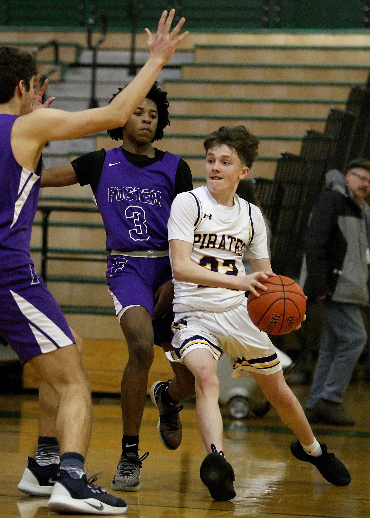 With Foster's full court press Matt Perkins of Highline looks to pass the ball to an open teammate.