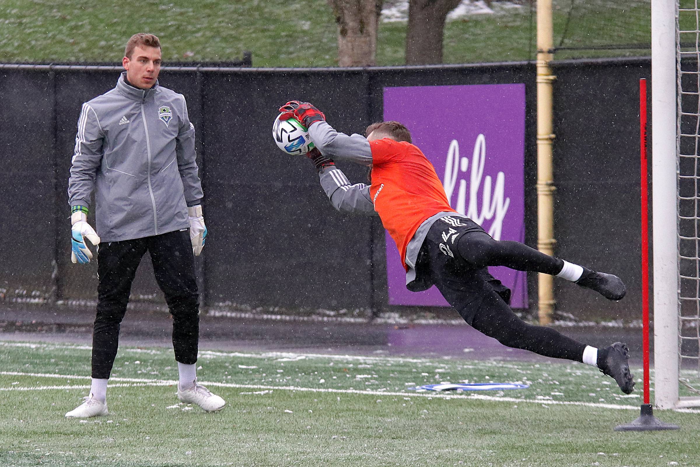 Goalie Stefan Frei (#24) demonstrates a diving save during the first practice of the 2020 season