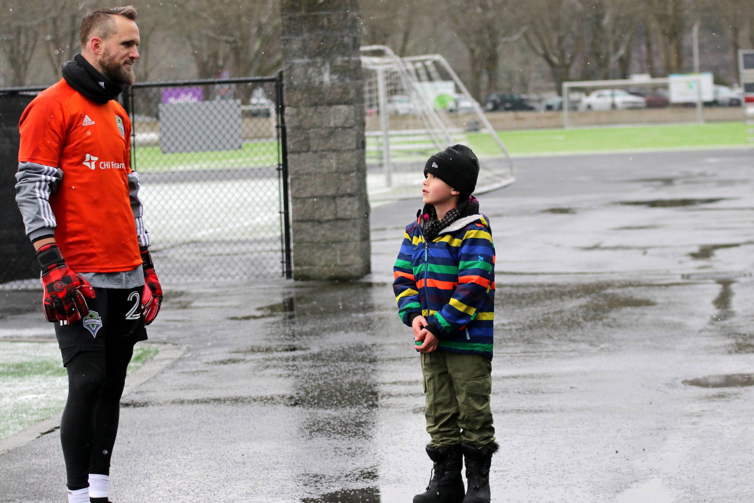 Stefan Frei (#24) talks with fans after practice and meets one aspiring future goalkeeper