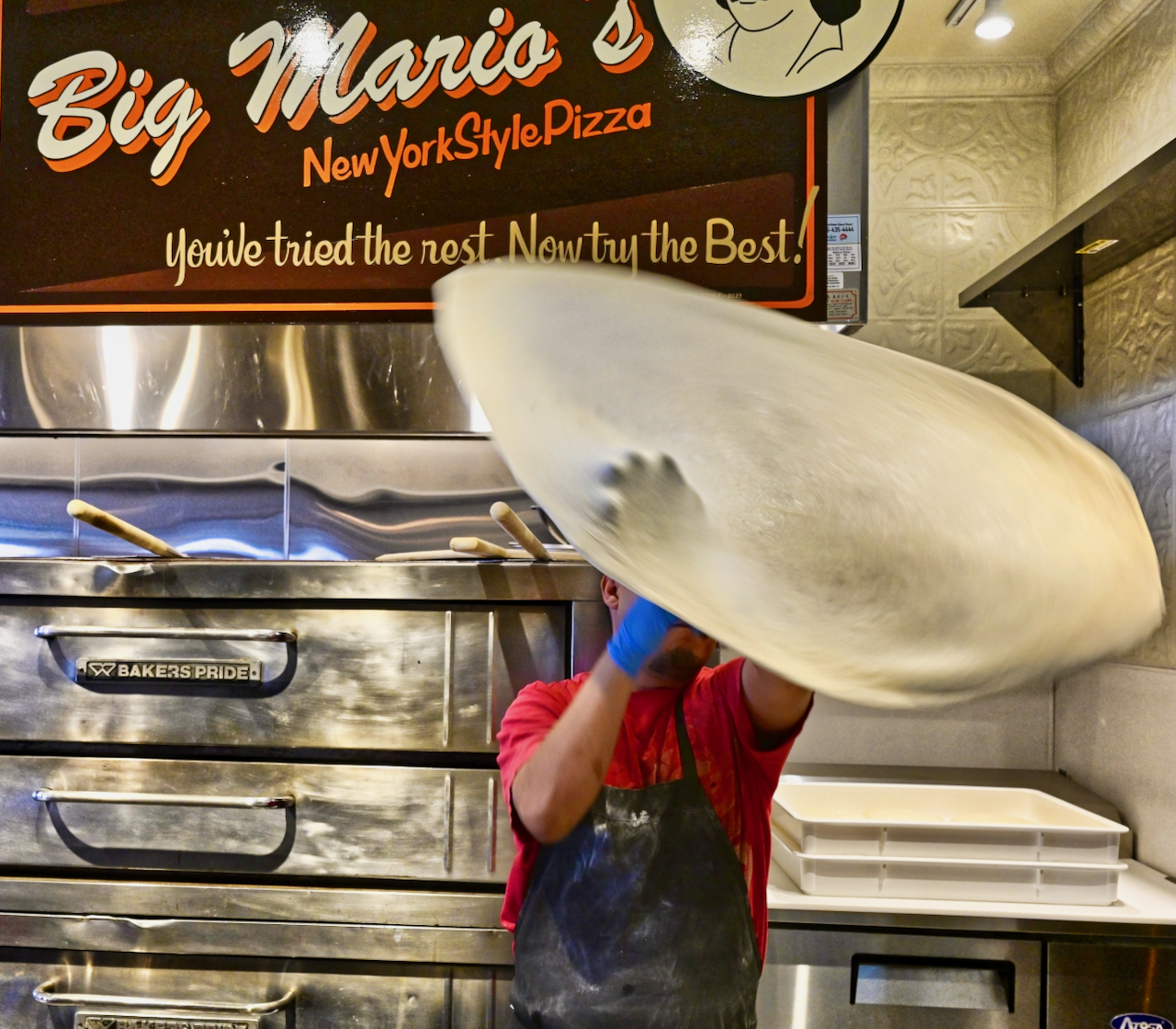 hand tossing pizza dough