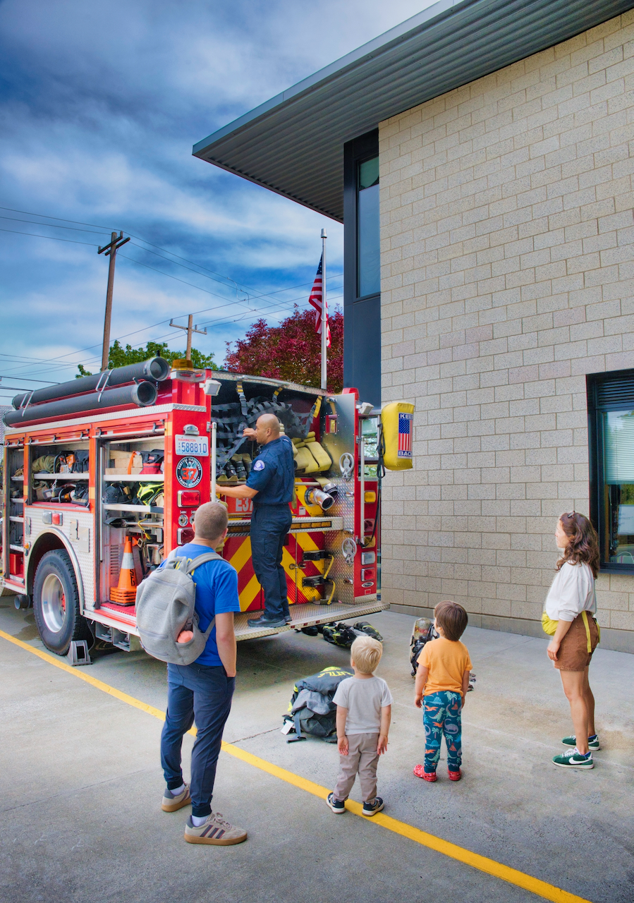 family inspecting a fire engine