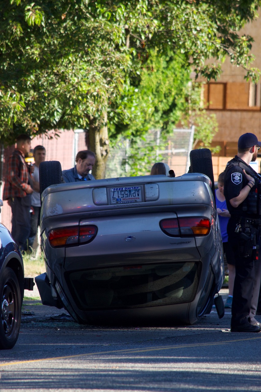 flipped car on Delridge- Photo by Kimberly Robinson - Westside Seattle