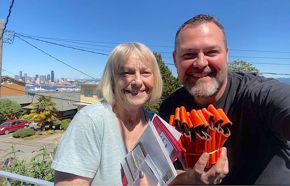 Judi & Worth Wheeler, Pastor of the West Seattle Christian Church posing with the $29,000 worth of gift cards purchased by WSCC & donated to the food bank.