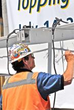 Toppingoff-3 Worker signs beam.jpg
