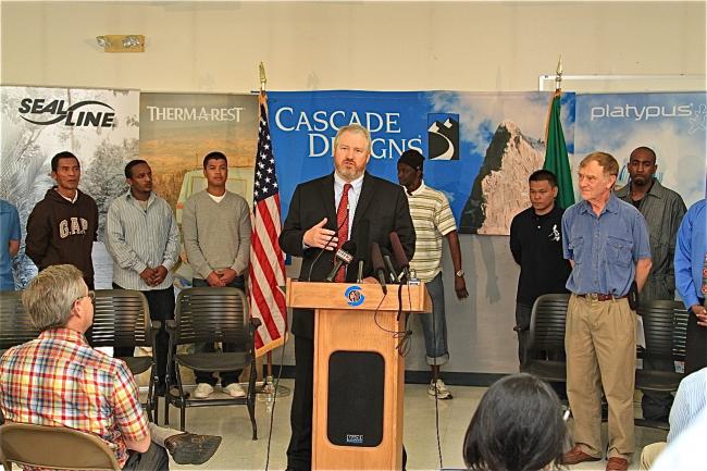 Mayor McGinn speaks in front of welding students with Cascade Designs co- founder John Burroughs (in blue shirt) watching.jpg