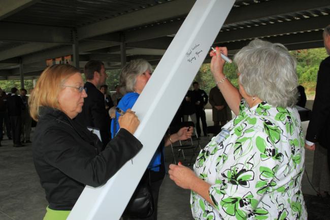 King County Councilperson Jan Drago and Burien City Councilperson Kathy Keene sign the beam.JPG