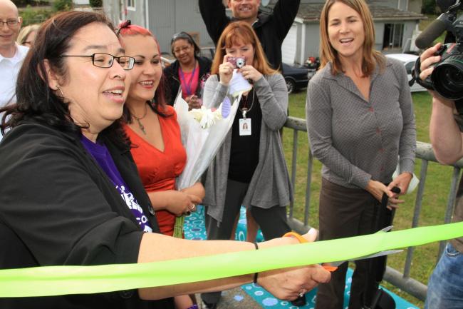 Norma Zavala, principle of Concord Elementary cuts the ribbon to officially open the Little Bridge.JPG